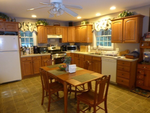 36 Torrey Street Easthampton, MA 01027 - Photo 7 of 20 a kitchen with a table chairs stove and refrigerator