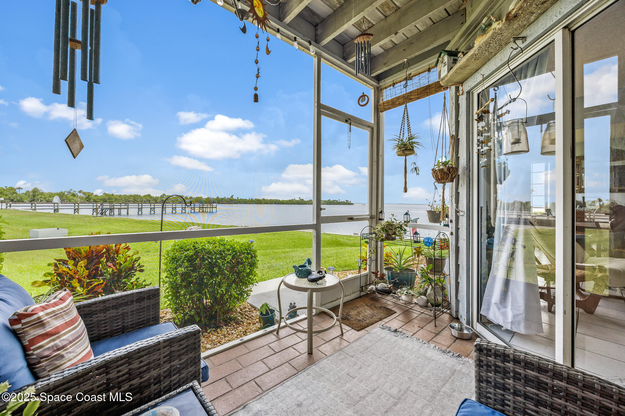 a patio with glass top table and chairs
