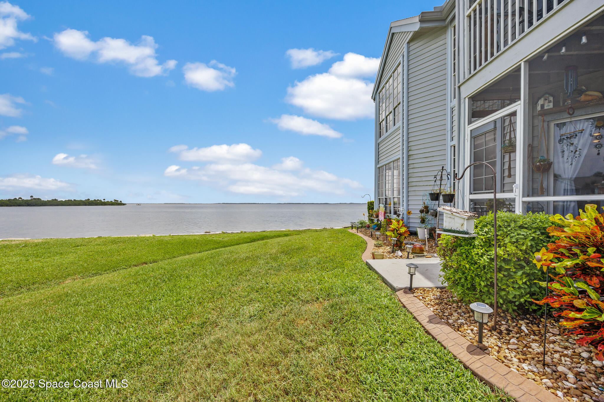 7420 U.S. Rte 1, Unit 106 Cocoa, FL 32927 - Photo 11 of 41 a view of a lake with a big yard