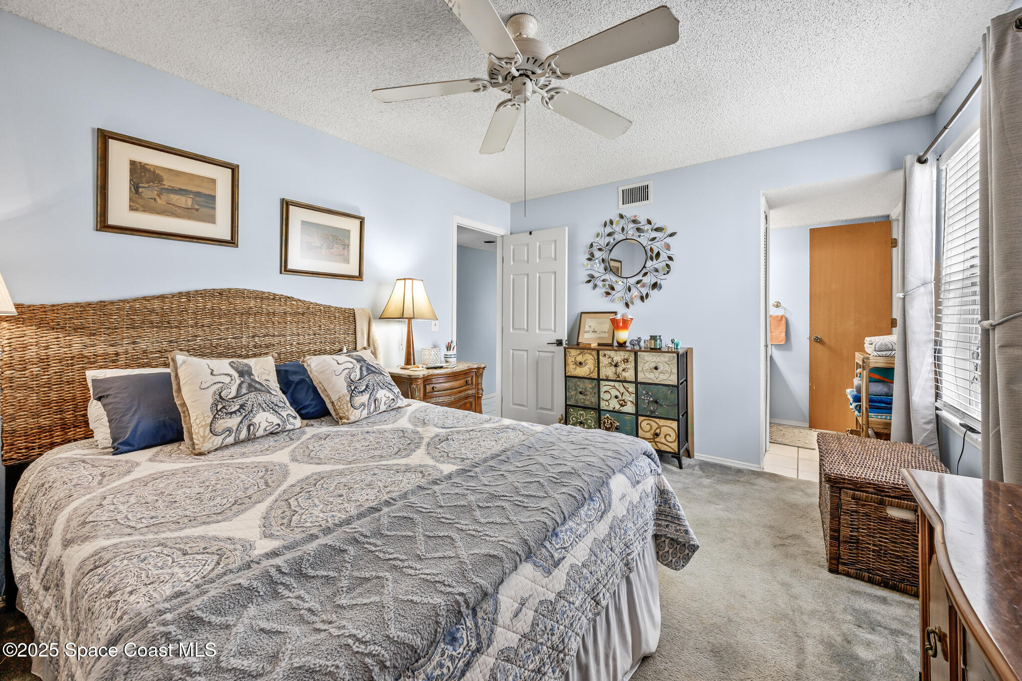 7420 U.S. Rte 1, Unit 106 Cocoa, FL 32927 - Photo 15 of 41 a bedroom with a large bed and a chandelier