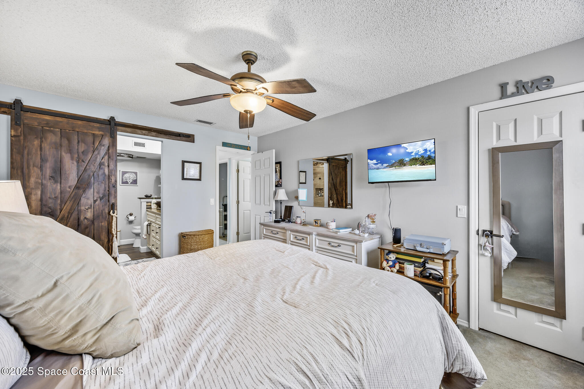 7420 U.S. Rte 1, Unit 106 Cocoa, FL 32927 - Photo 22 of 41 a bedroom with a bed and a chandelier