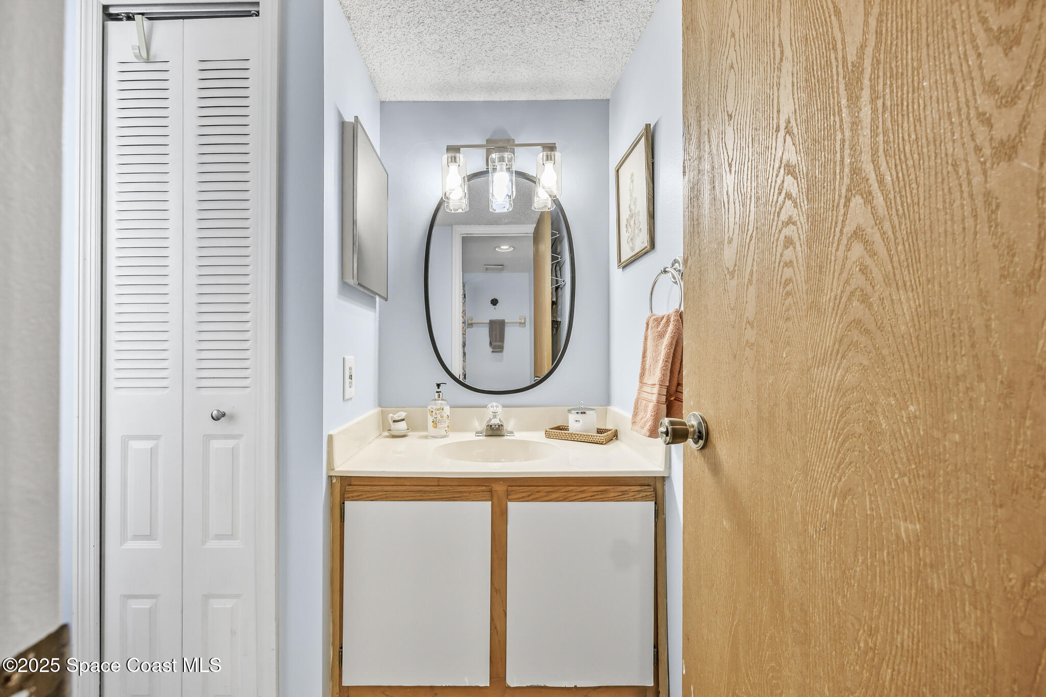 7420 U.S. Rte 1, Unit 106 Cocoa, FL 32927 - Photo 24 of 41 a bathroom with a sink and a mirror