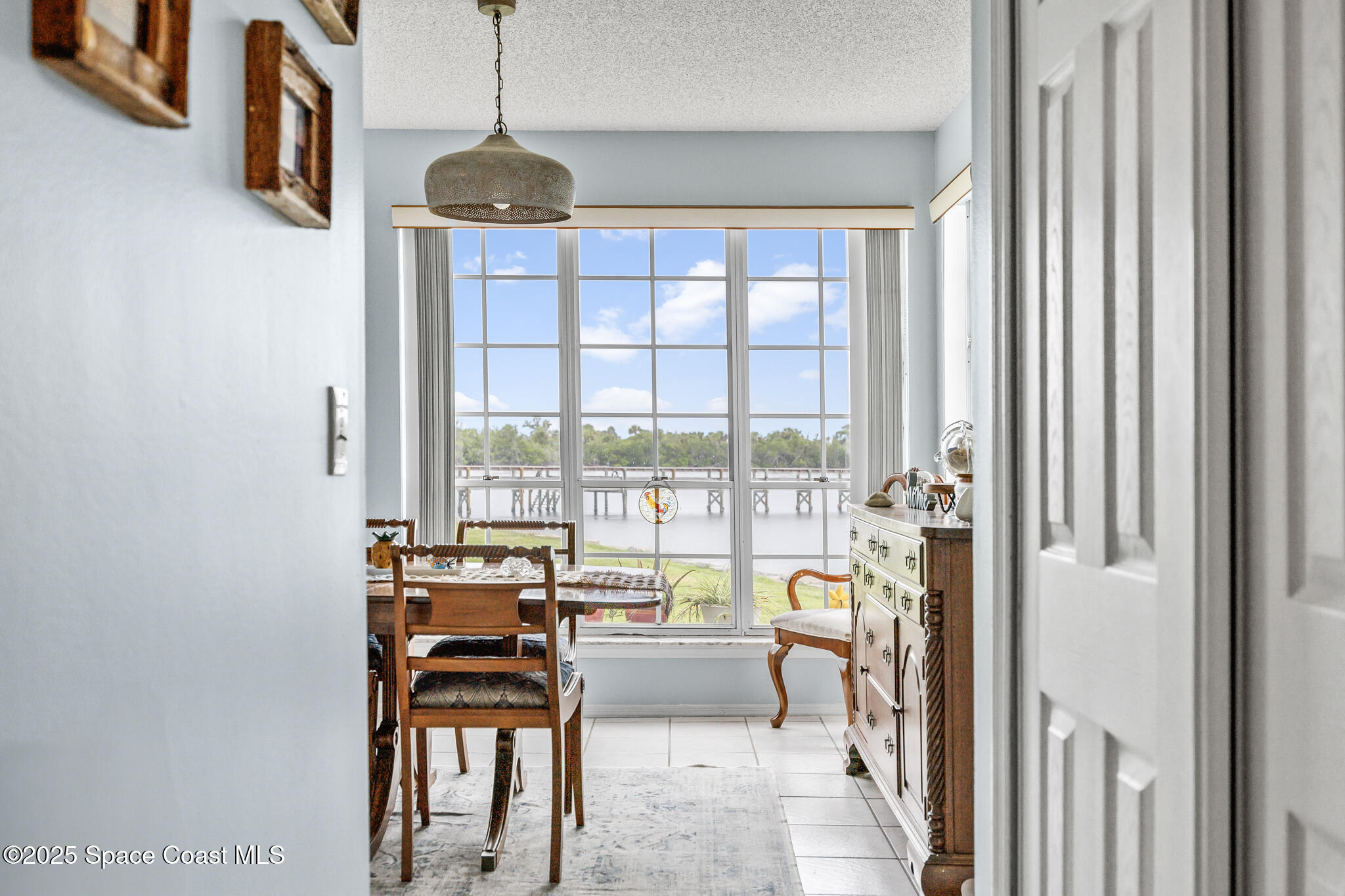 7420 U.S. Rte 1, Unit 106 Cocoa, FL 32927 - Photo 26 of 41 a living room with furniture and a floor to ceiling window