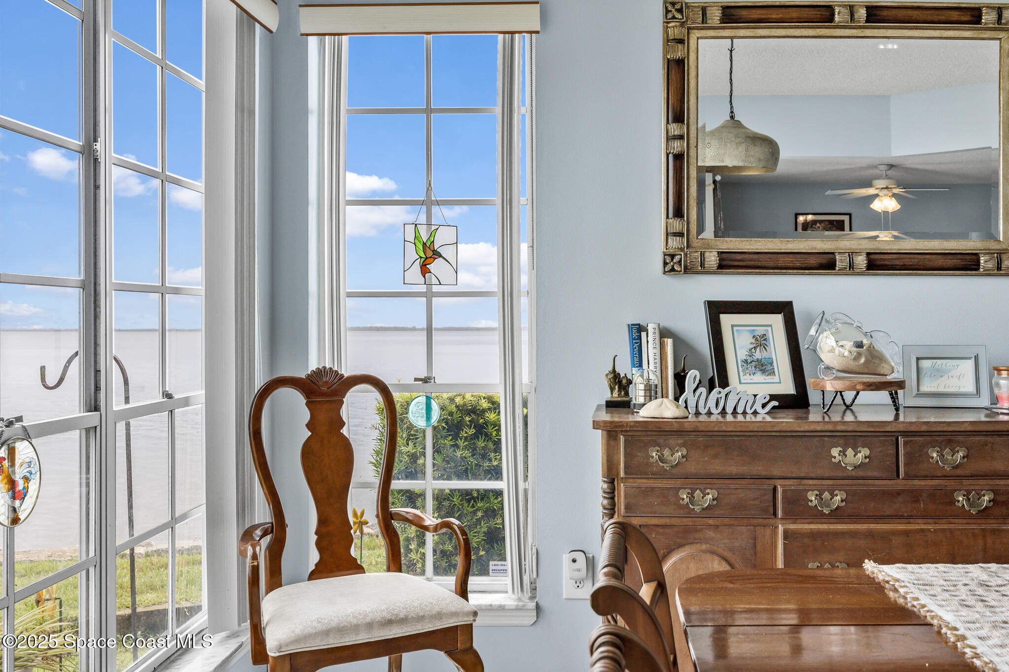 7420 U.S. Rte 1, Unit 106 Cocoa, FL 32927 - Photo 29 of 41 a room with chandelier fan and windows