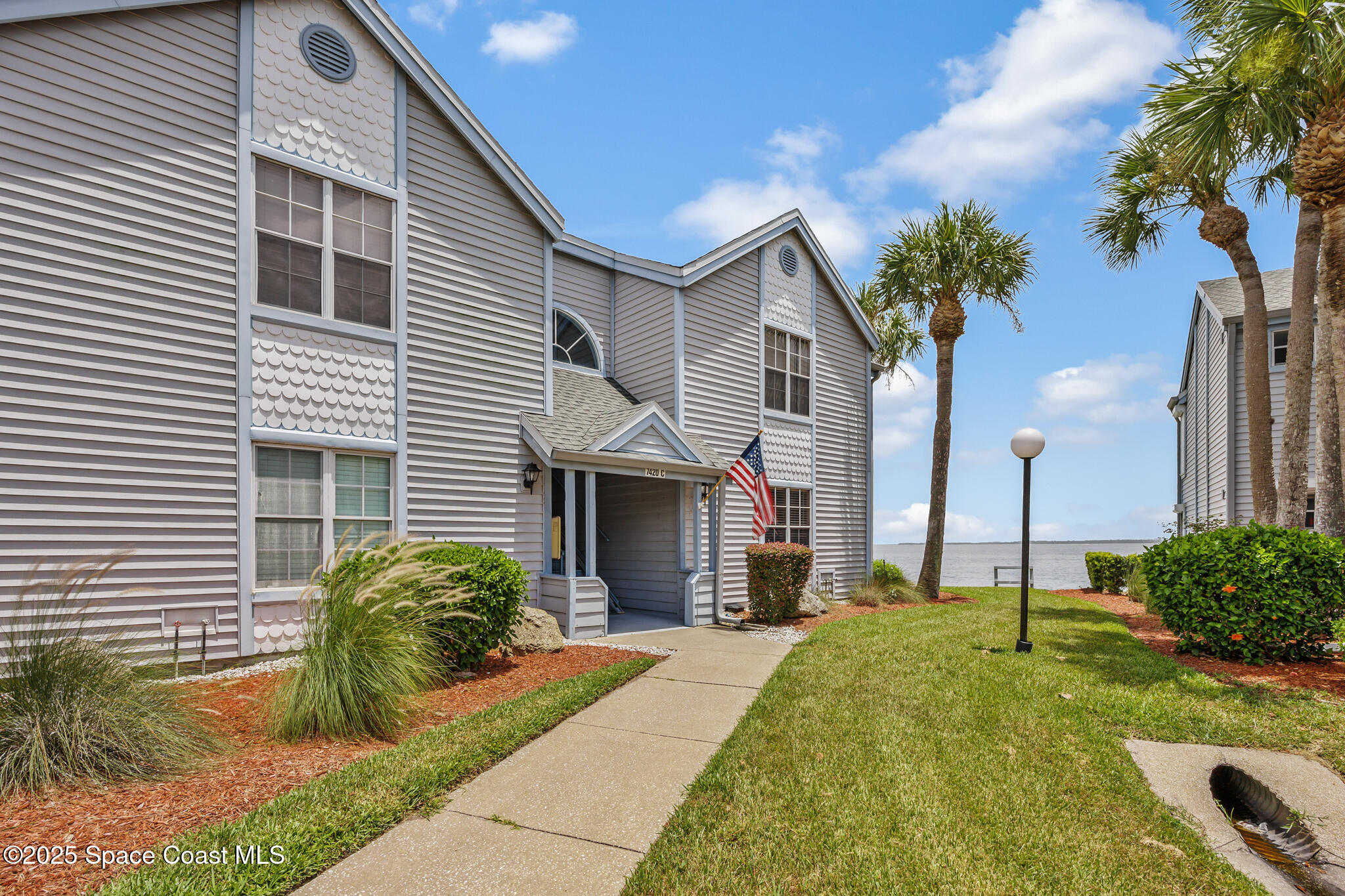 7420 U.S. Rte 1, Unit 106 Cocoa, FL 32927 - Photo 3 of 41 a front view of a house with a yard