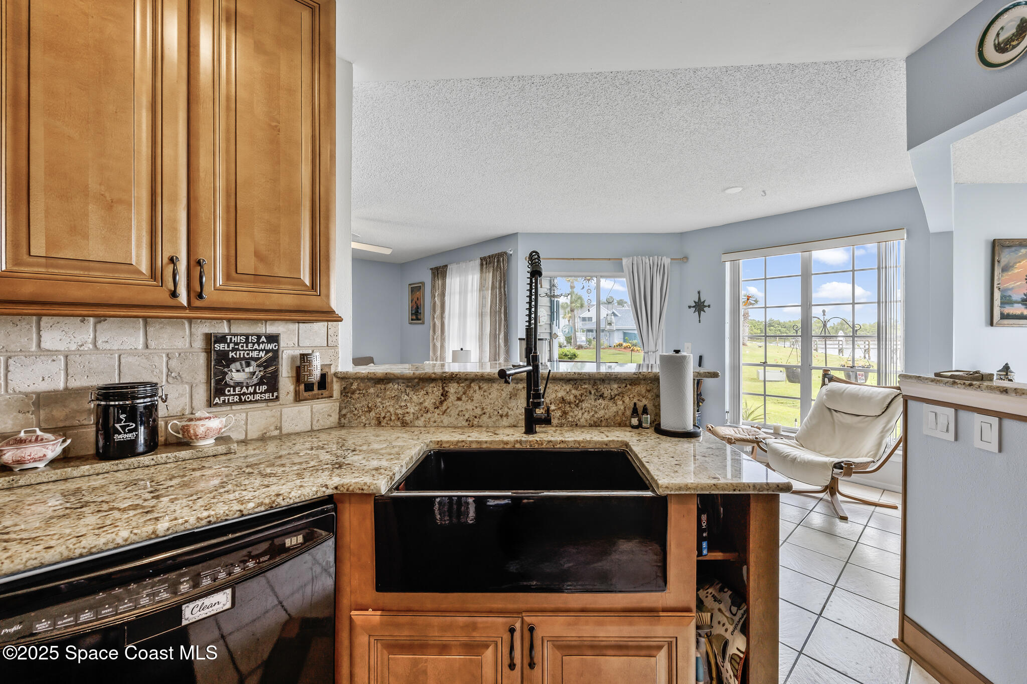 7420 U.S. Rte 1, Unit 106 Cocoa, FL 32927 - Photo 32 of 41 a kitchen with granite countertop a stove a sink dishwasher and cabinets with wooden floor