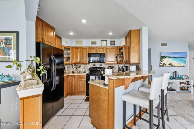 a kitchen with appliances cabinets and chair