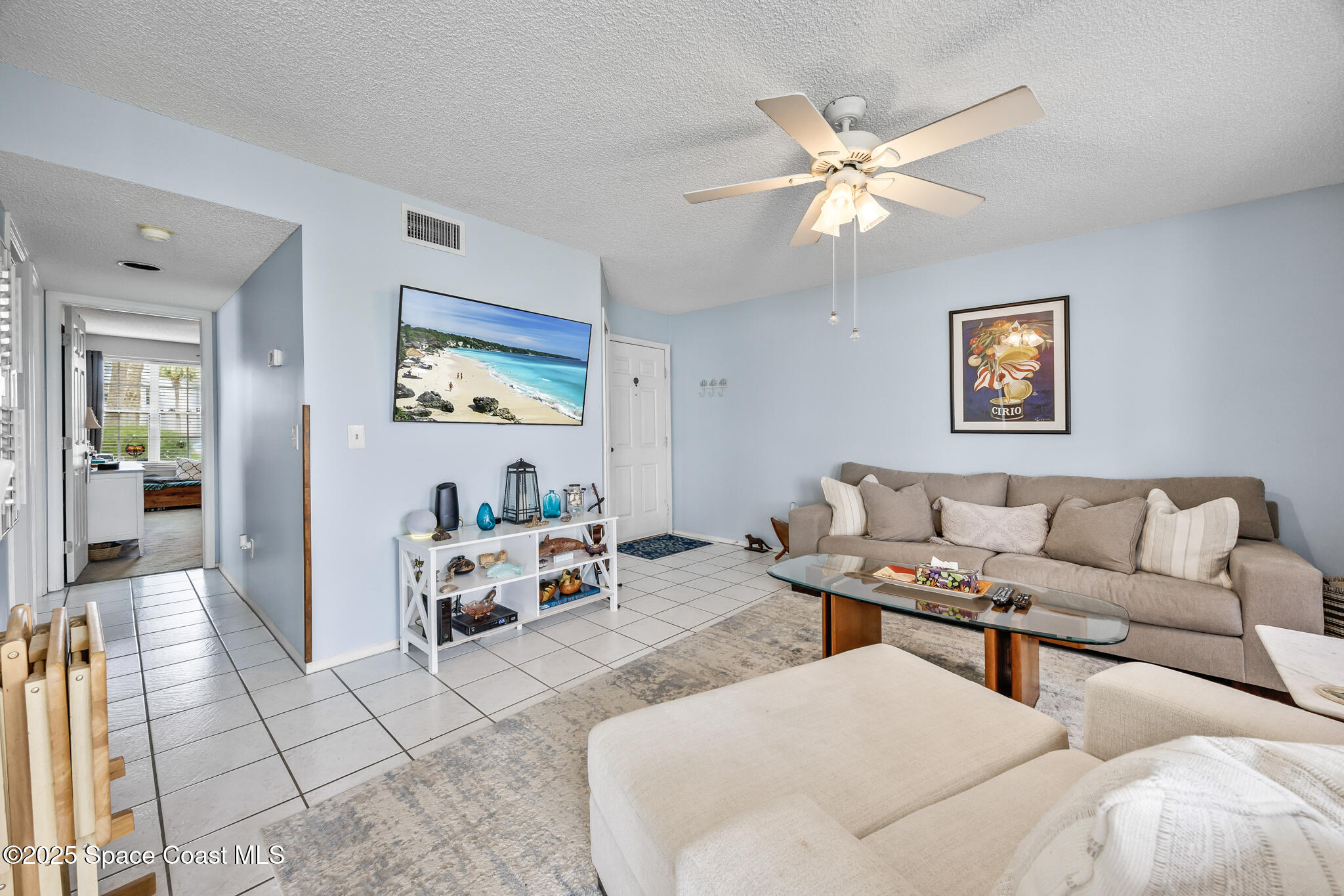 7420 U.S. Rte 1, Unit 106 Cocoa, FL 32927 - Photo 37 of 41 a living room with furniture and wall paintings