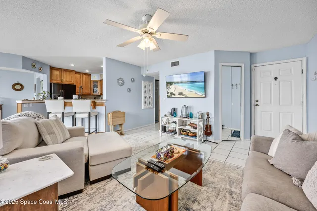 a living room with furniture a flat screen tv and a window