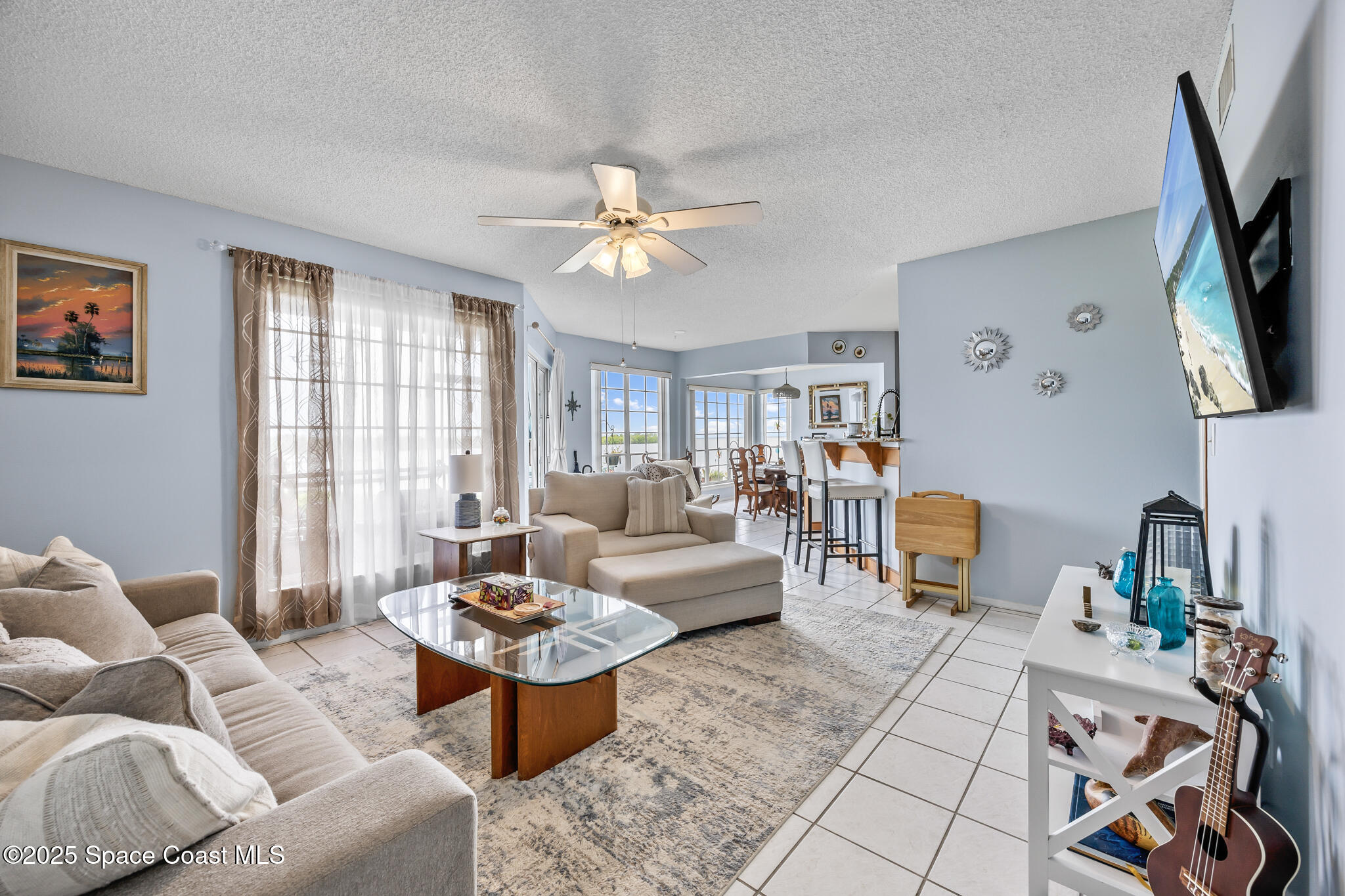 7420 U.S. Rte 1, Unit 106 Cocoa, FL 32927 - Photo 39 of 41 a living room with furniture a flat screen tv and a window