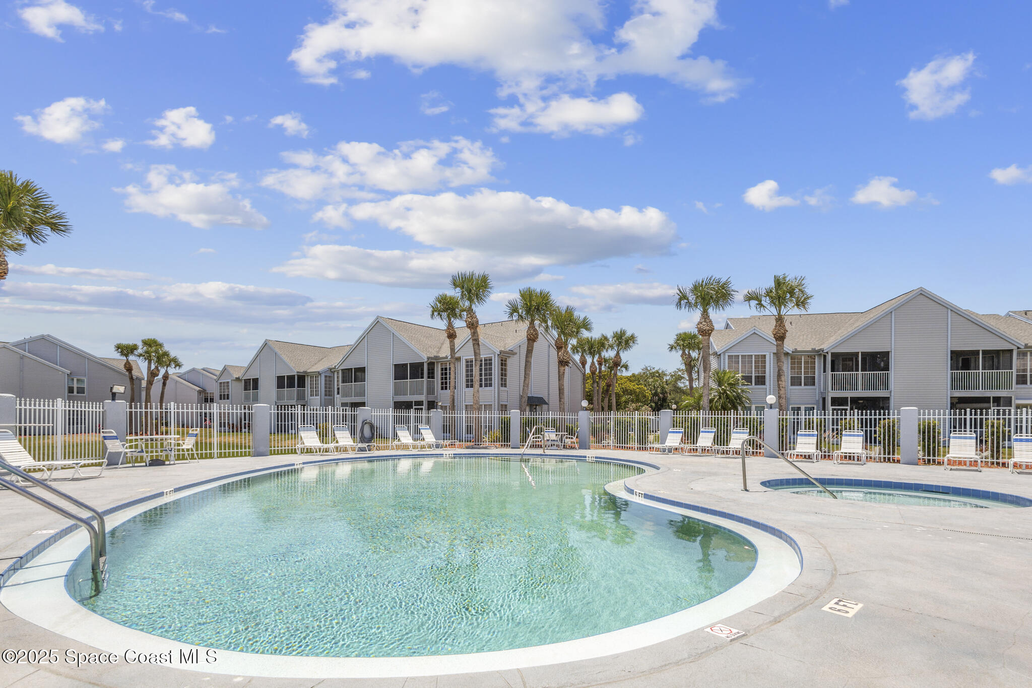 7420 U.S. Rte 1, Unit 106 Cocoa, FL 32927 - Photo 7 of 41 a view of a swimming pool in front of residential houses