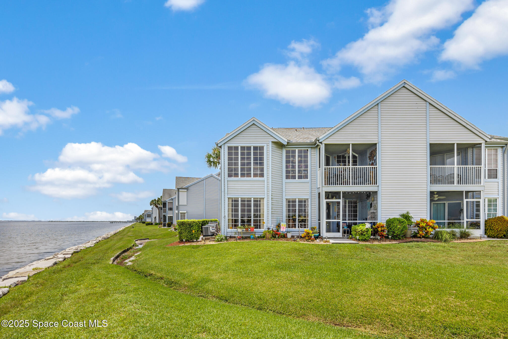 7420 U.S. Rte 1, Unit 106 Cocoa, FL 32927 - Photo 10 of 41 a view of a house with a big yard and large trees