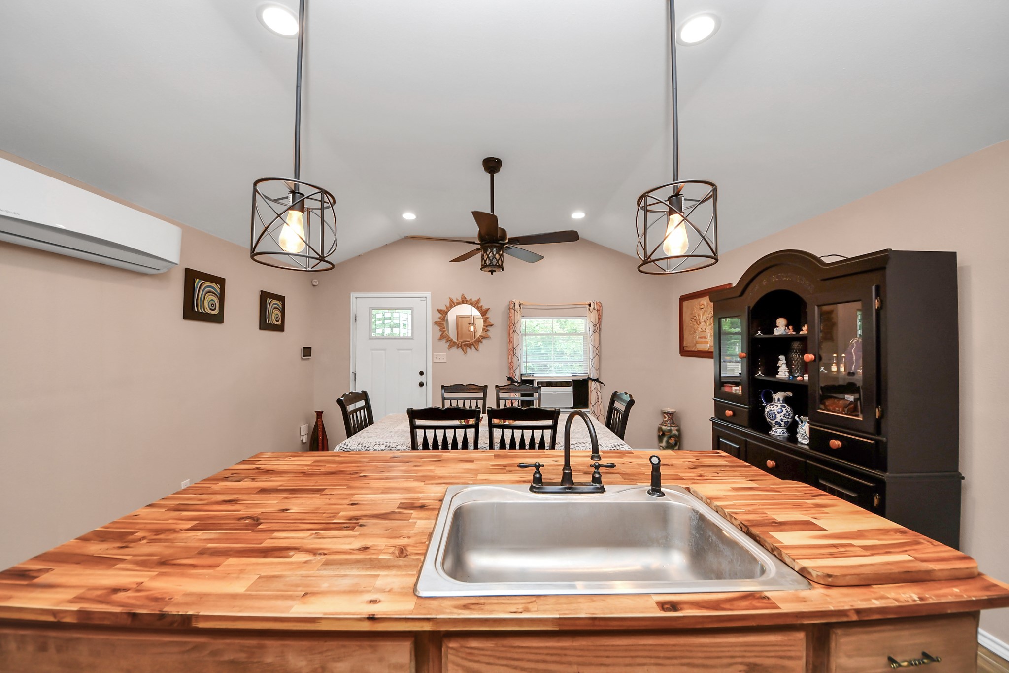 14961 Lamar Road Willis, TX 77378 - Photo 14 of 31 View from kitchen showcasing oversized breakfast bar overlooking open dining/living area.