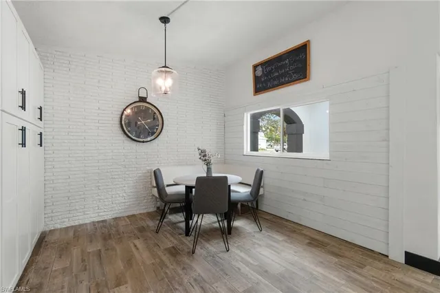a view of a dining room with furniture wooden floor and a window