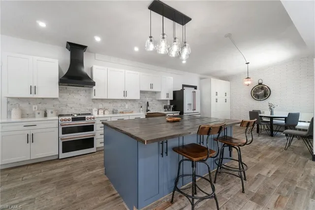 a kitchen with cabinets and chairs
