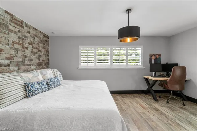 a bedroom with a bed and a lamp on table