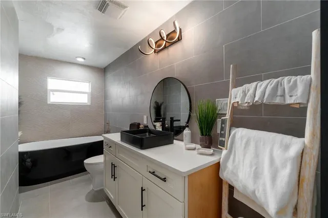 a bedroom with furniture and wooden floor