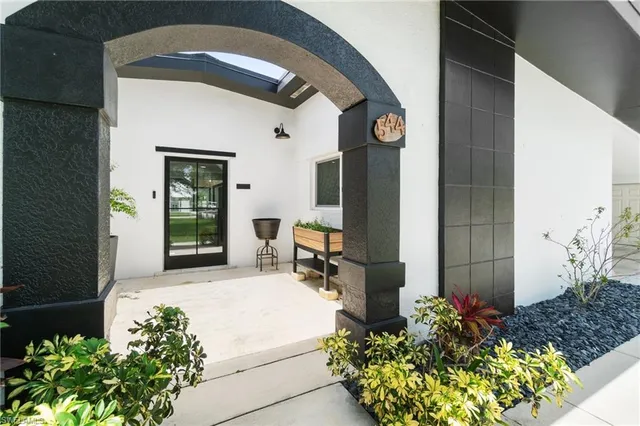 a lobby with furniture and a potted plant