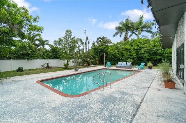a view of house with a backyard