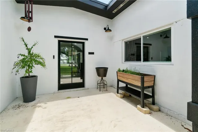 a bedroom with a bed and a potted plant