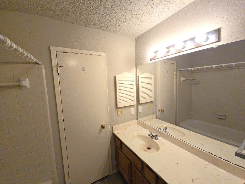 15625 Weldon Drive Houston, TX 77032 - Photo 16 of 25 a bathroom with a shower sink double vanity and mirror