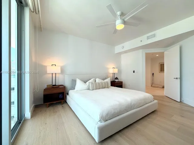 a bedroom with a bed and a chandelier