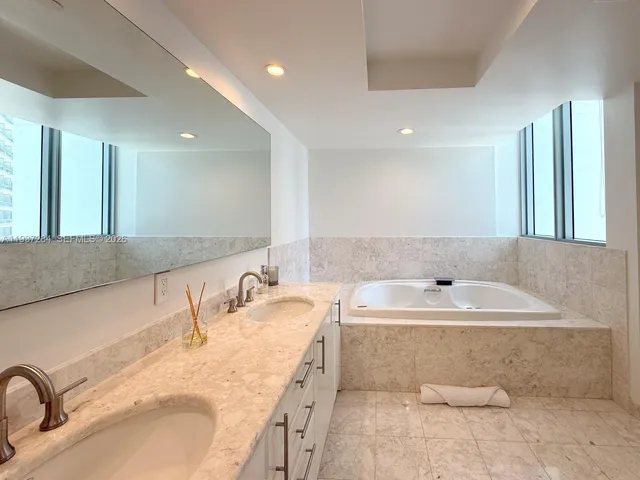 a bathroom with a double vanity sink and a mirror