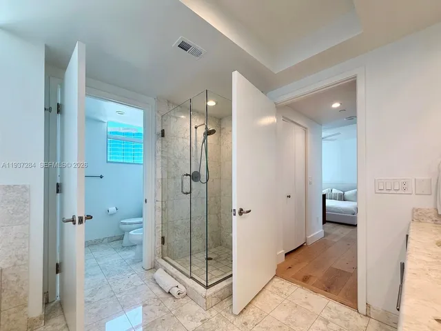 a bathroom with a shower and a toilet