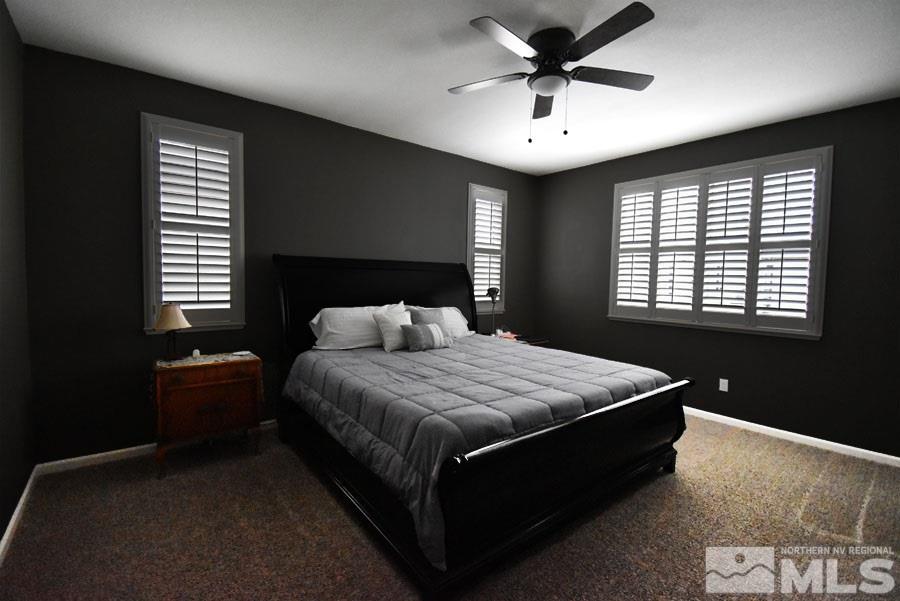 1955 Hope Valley Drive Reno, NV 89521 - Photo 8 of 16 a bedroom with a bed and a chandelier