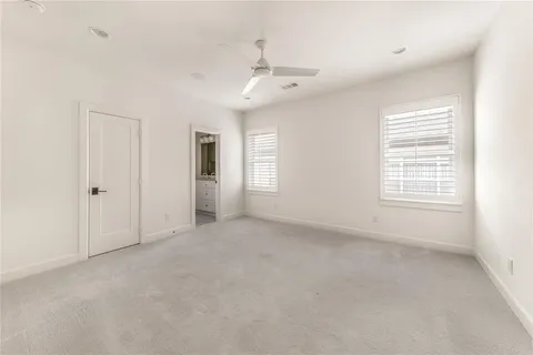 a kitchen with white cabinets and sink