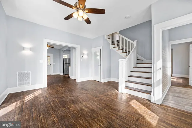 a view of entryway and hall with wooden floor