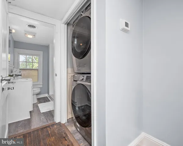 a bathroom with a sink toilet and window