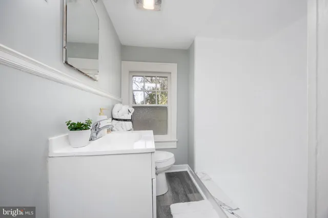 a white toilet sitting next to a bathroom sink