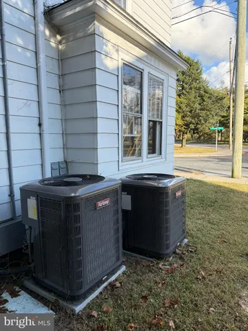 a view of a white house with a yard