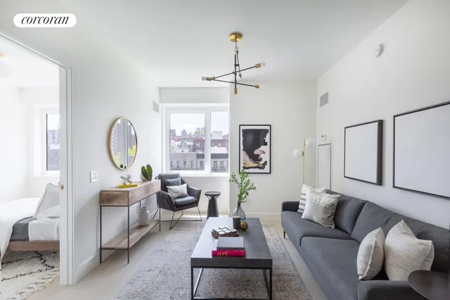 a living room with furniture ceiling fan and a window
