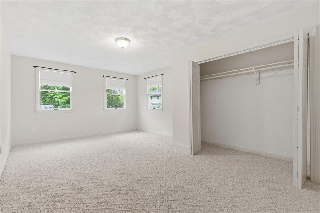 3 Spruce Street Stoneham, MA 02180 - Photo 11 of 38 an empty room with windows and closet