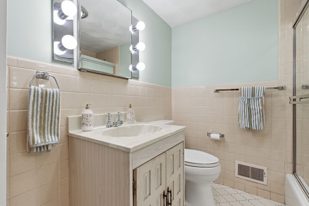 3 Spruce Street Stoneham, MA 02180 - Photo 12 of 38 a bathroom with a sink a toilet and mirror