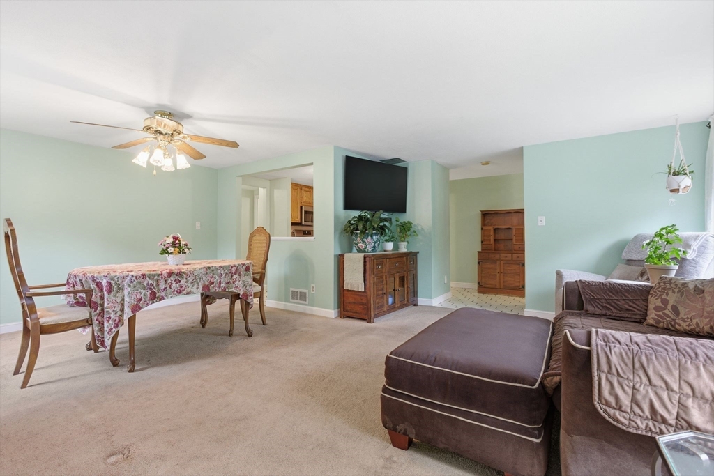 3 Spruce Street Stoneham, MA 02180 - Photo 18 of 38 a living room with furniture a flat screen tv and a fireplace