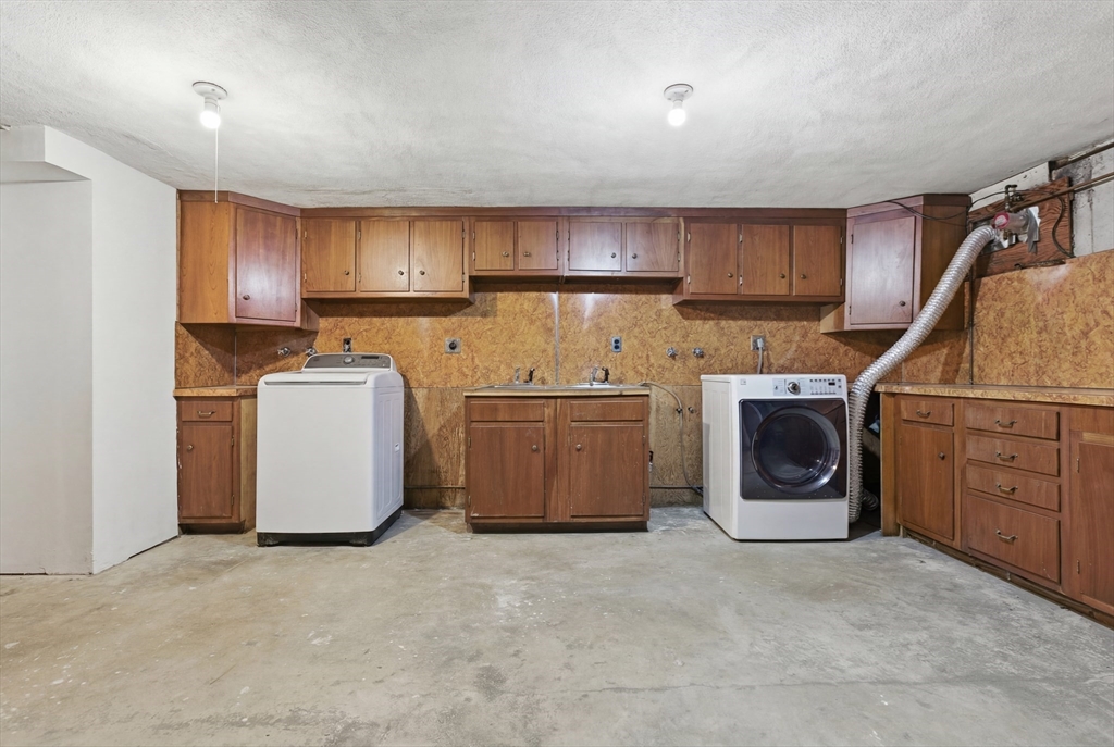 3 Spruce Street Stoneham, MA 02180 - Photo 31 of 38 a utility room with cabinets washer and dryer