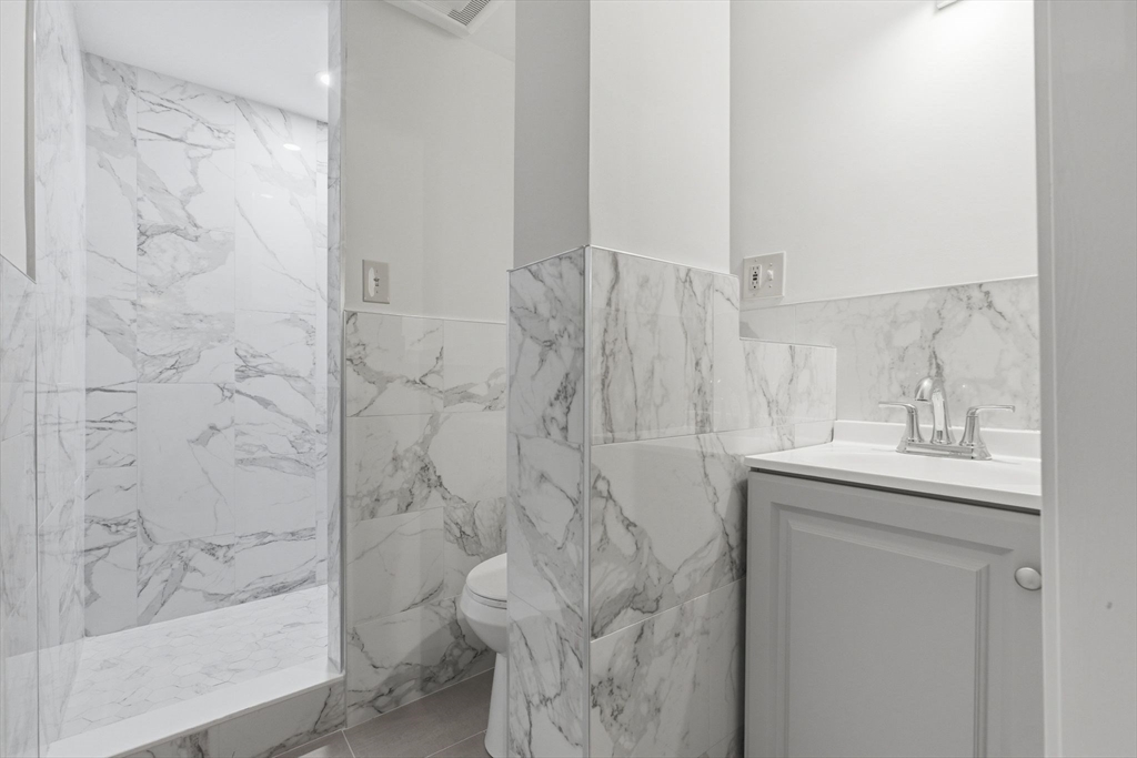 3 Spruce Street Stoneham, MA 02180 - Photo 33 of 38 a bathroom with a shower and a sink