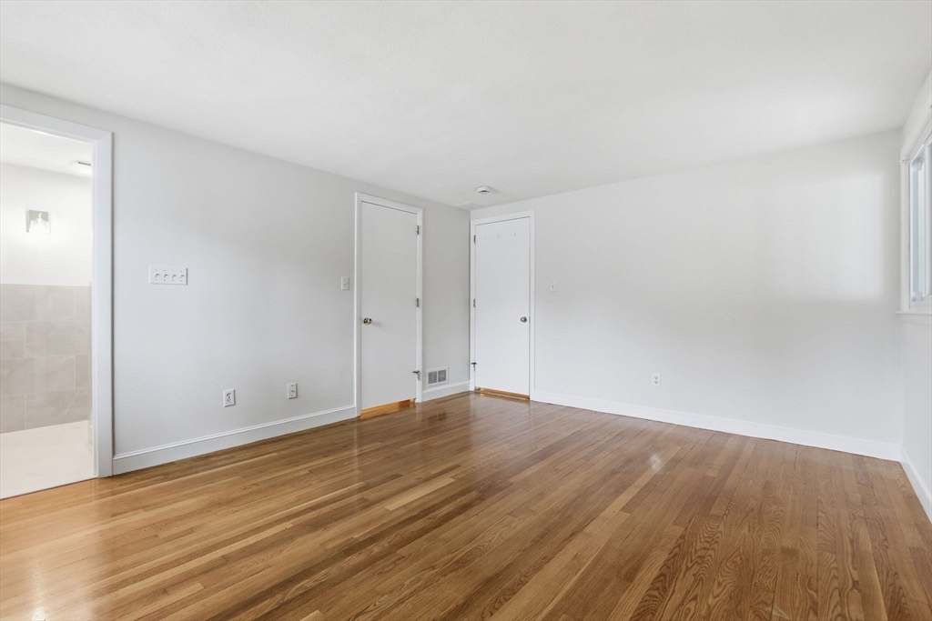 3 Spruce Street Stoneham, MA 02180 - Photo 8 of 38 a view of an empty room with wooden floor