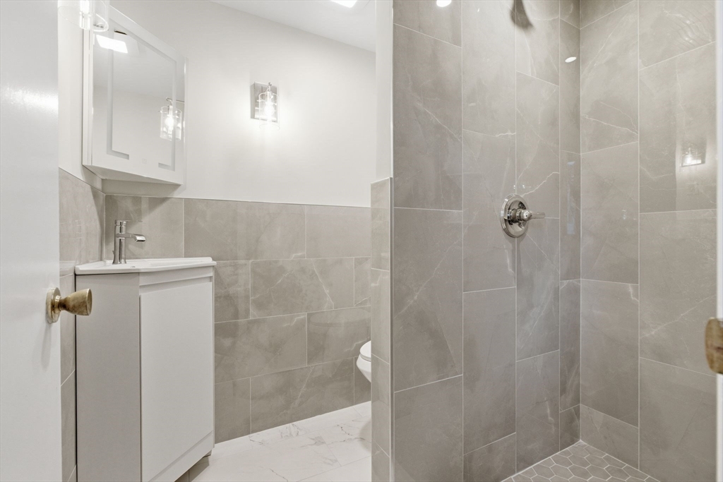 3 Spruce Street Stoneham, MA 02180 - Photo 10 of 38 a bathroom with a shower