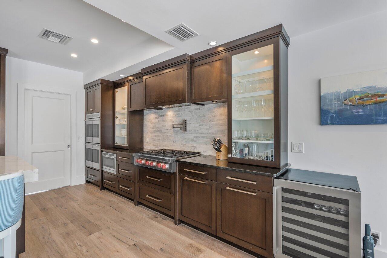 1041 Gulfstream Way Singer Island, FL 33404 - Photo 11 of 41 a kitchen with stainless steel appliances a stove and a refrigerator
