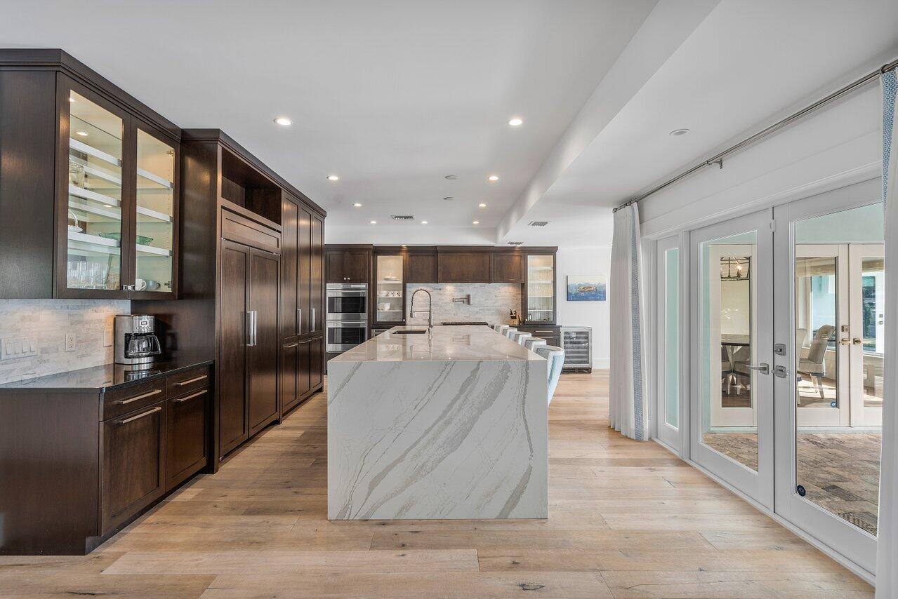 1041 Gulfstream Way Singer Island, FL 33404 - Photo 12 of 41 a large kitchen with stainless steel appliances kitchen island granite countertop a large counter top cabinets and stainless steel appliances