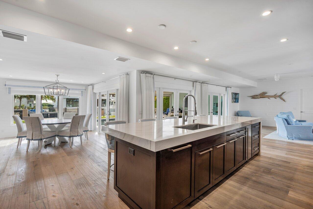 1041 Gulfstream Way Singer Island, FL 33404 - Photo 13 of 41 a kitchen with counter top space sink and center island