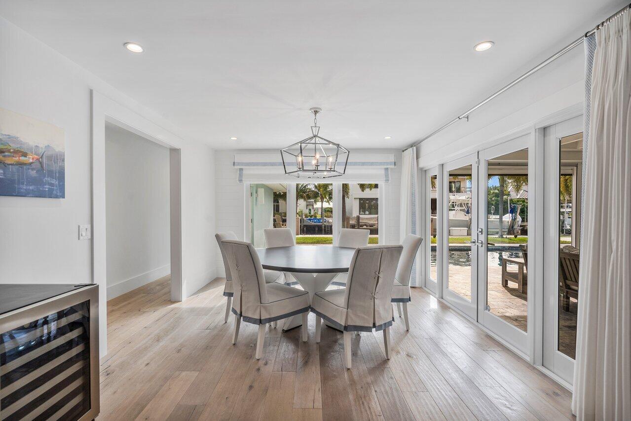 1041 Gulfstream Way Singer Island, FL 33404 - Photo 14 of 41 a view of a dining room with furniture window and wooden floor