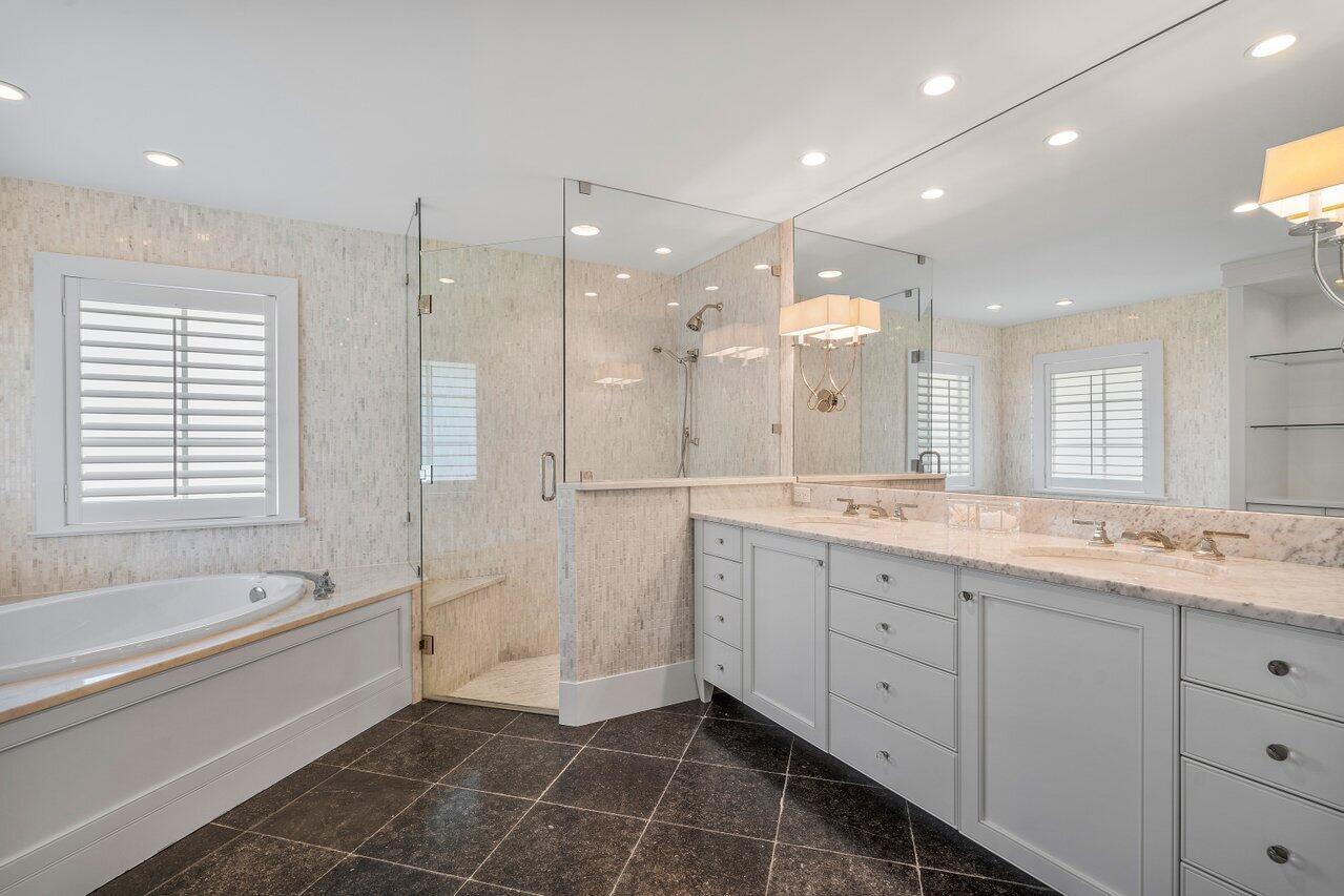 1041 Gulfstream Way Singer Island, FL 33404 - Photo 18 of 41 a spacious bathroom with a large mirror vanity and shower