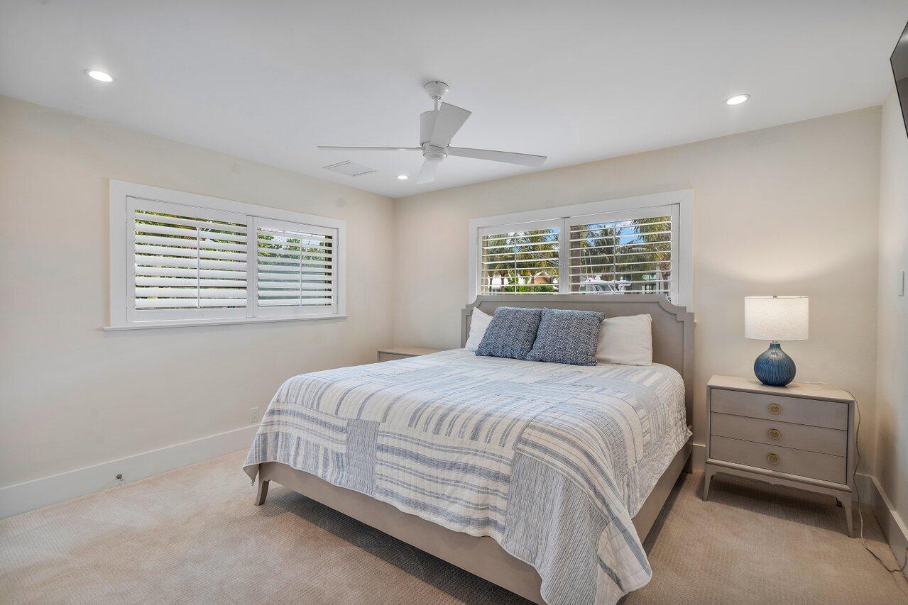 1041 Gulfstream Way Singer Island, FL 33404 - Photo 24 of 41 a bedroom with a bed and a window