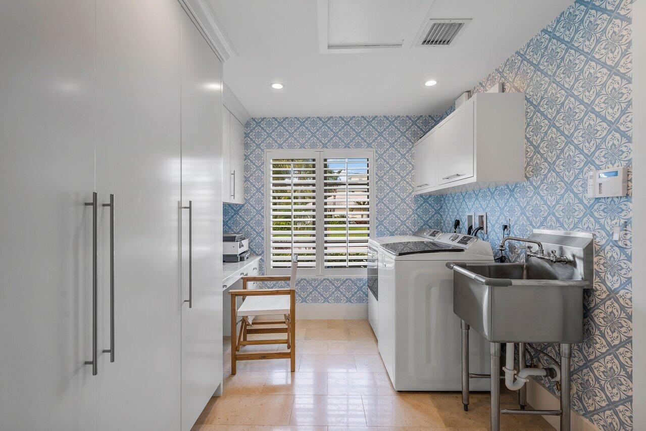 1041 Gulfstream Way Singer Island, FL 33404 - Photo 25 of 41 a kitchen a sink a refrigerator and chairs