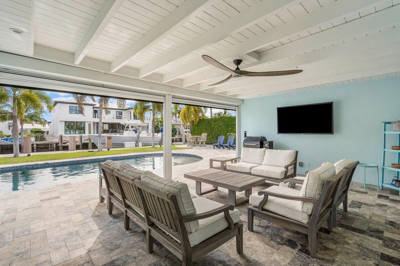 1041 Gulfstream Way Singer Island, FL 33404 - Photo 26 of 41 a living room with a flat screen tv and a floor to ceiling window